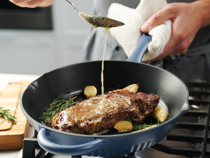 How to season cast iron: searing steak in a Tramontina skillet, basting with butter and herbs