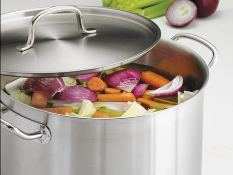 Stock vs broth: onion, carrot, and celery simmering in water in a Tramontina stainless steel stock pot